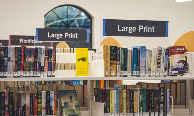 Book Shelves with a Large Print Sign