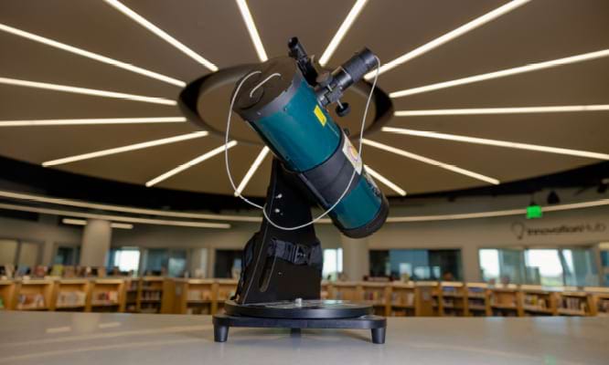 Telescope on a library desk.