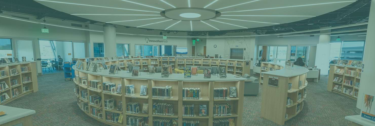 Public library interior with bookshelves and displays of books.