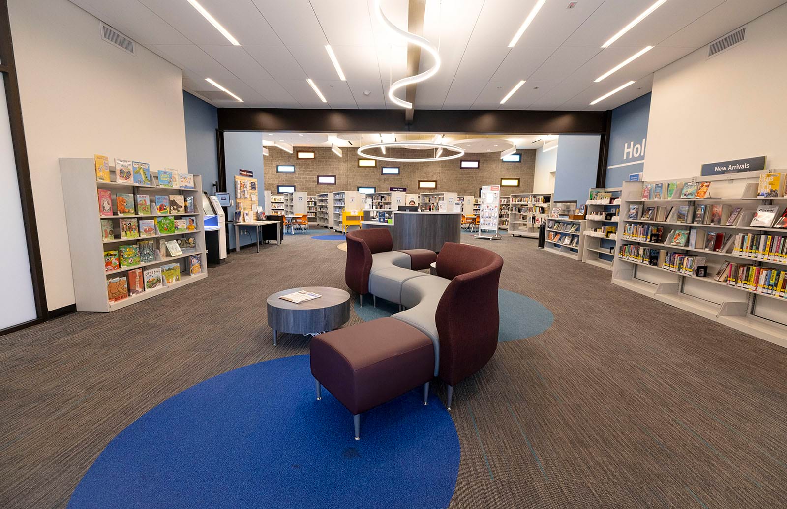 Photo from the entrance of the library of seating and shelves