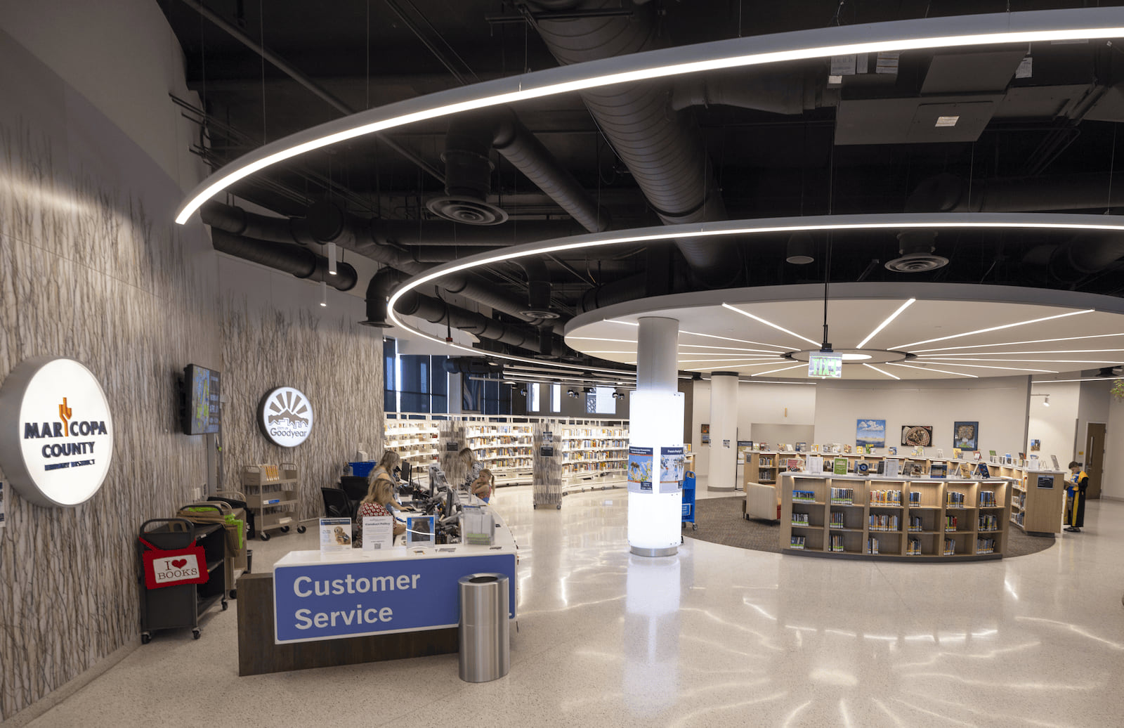 Photo from the north entrance of the library of the Customer Service desk and kids shelves