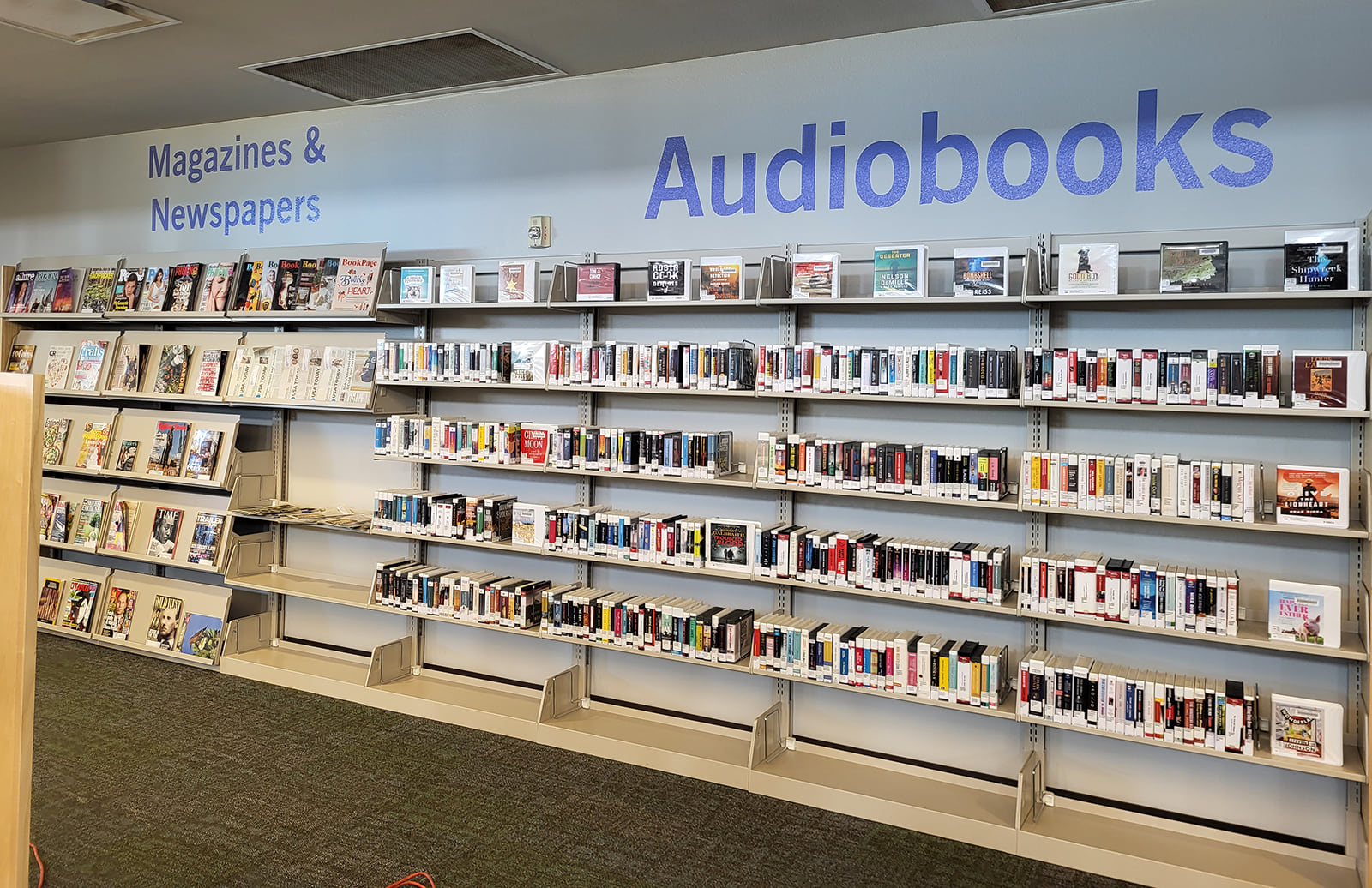 Photo of audiobooks, magazines and newspapers shelves