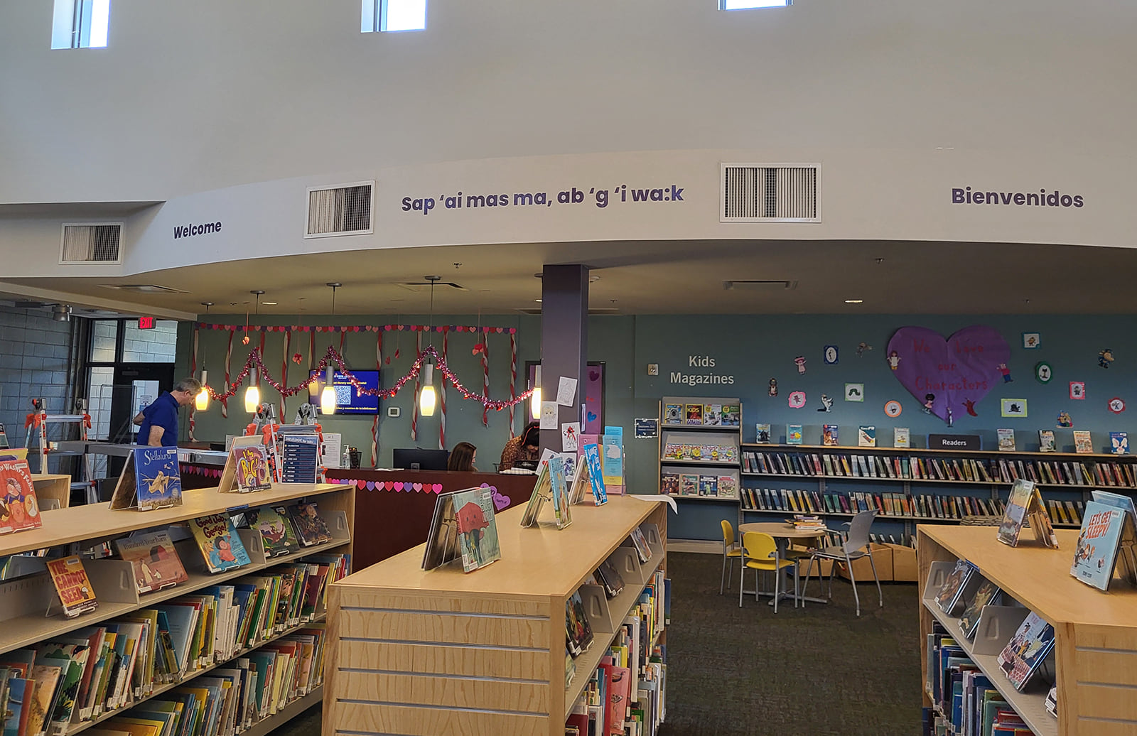 Photo of picture book shelves, the kids area and the service desk
